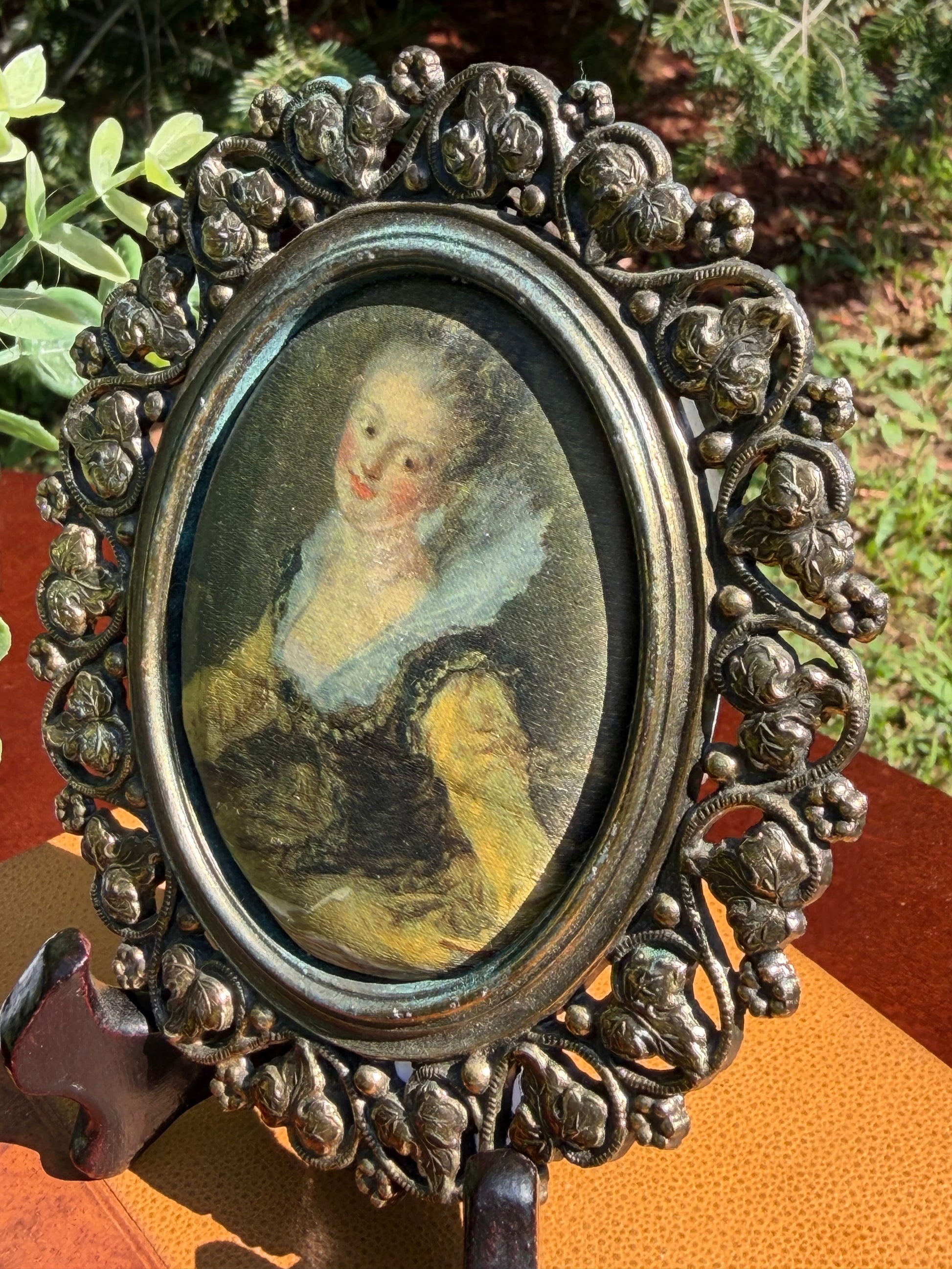 Reverse of miniature portrait showing burgundy velvet backing and hanging loop