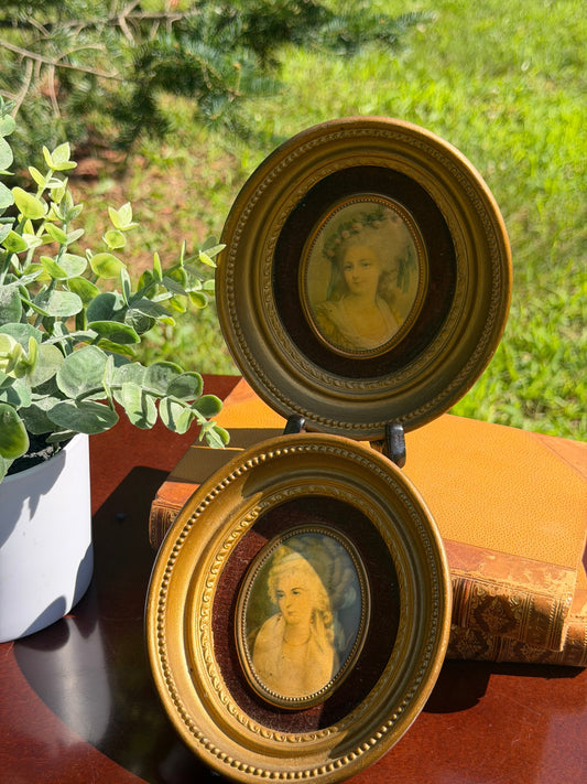 Overhead view of both Cameo Creation frames showing gilt backs and hanging loops