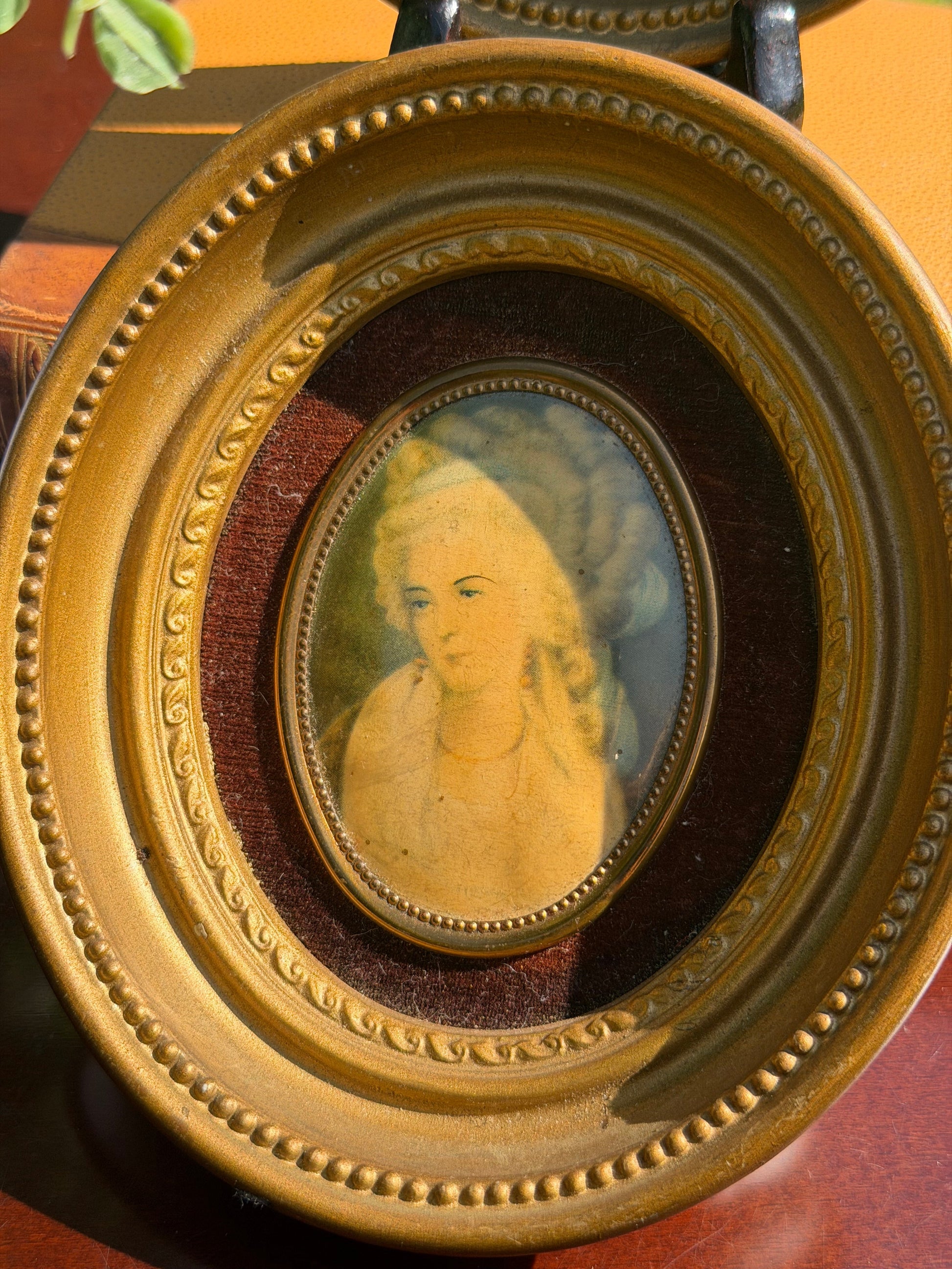 Close-up of Princess Lamballe miniature portrait in gilt frame with burgundy velvet mat