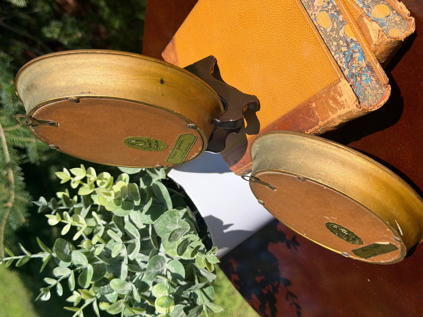 Close-up of Cameo Creation maker label and hanging hardware on reverse of frame