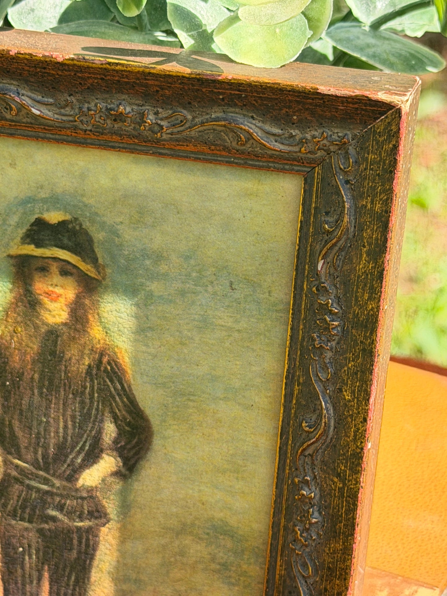 Lower corner detail of ornate dark wood frame showing floral and scrollwork carving