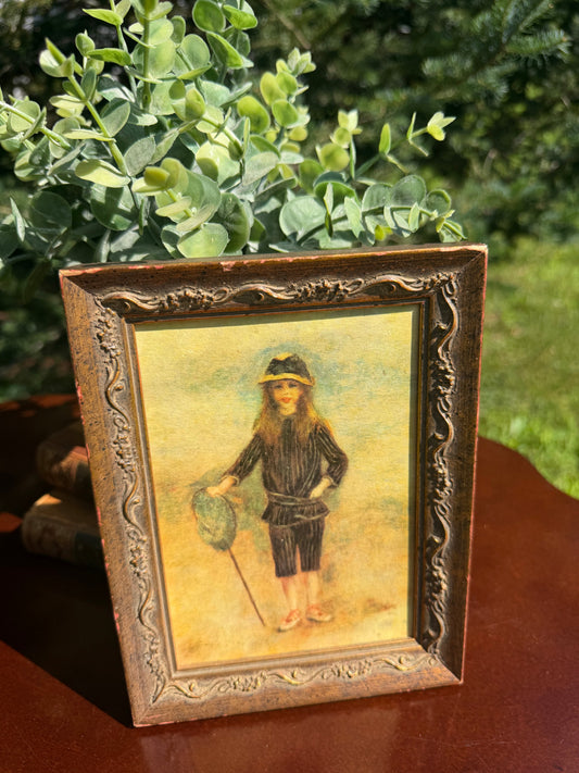 Full front view of Renoir Fisher Boy print in ornate dark wood frame in natural light