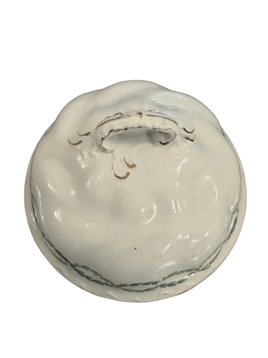 Antique white porcelain dome lid with rope-twist band, scalloped edge, and arched scroll handle
